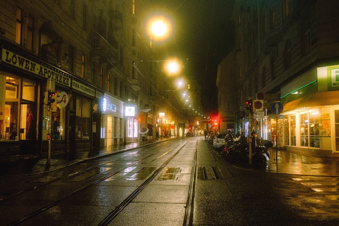 Foggy old European street at night with a single lit lamp