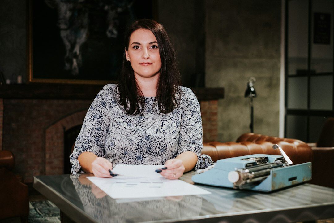 writer sitting at desk with notebook