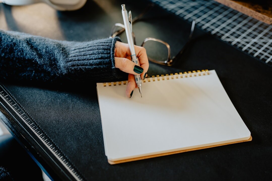 person writing in notebook